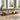 Long wooden console table in a living room with decor items and a rug.