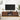 Wooden TV stand with a television mounted on a white wall, surrounded by decorative items.