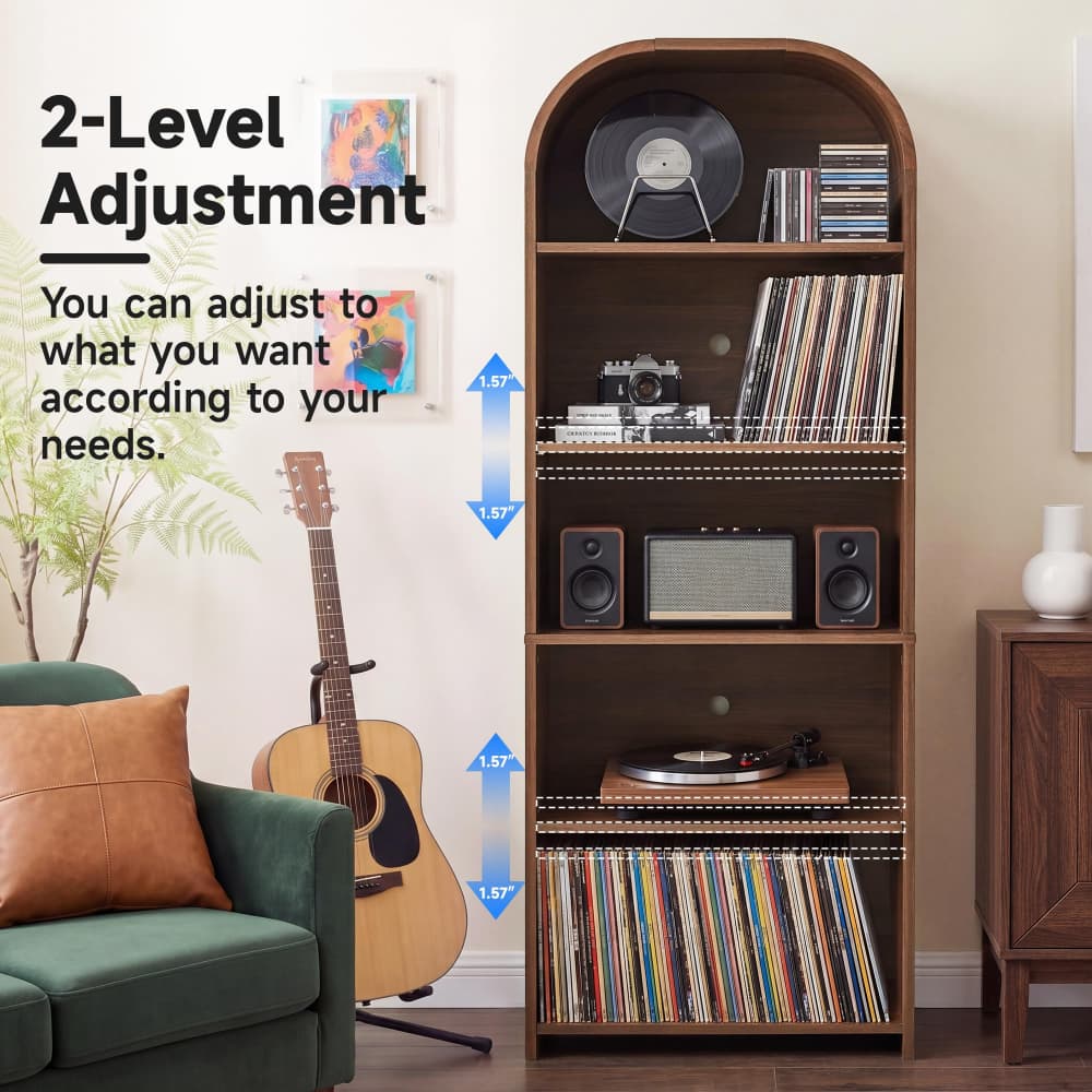 A tall wooden 2-level record shelf with an arched top, styled in a living room setting next to a green sofa and an acoustic guitar. The shelf is filled with vinyl records, speakers, a turntable, and CDs, with text overlays explaining the adjustable 15-inch shelf height.