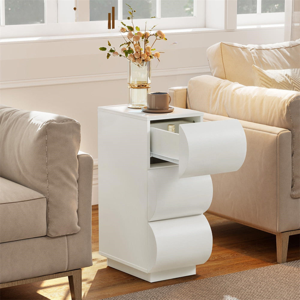 White side table with a drawer next to a beige sofa in a living room.