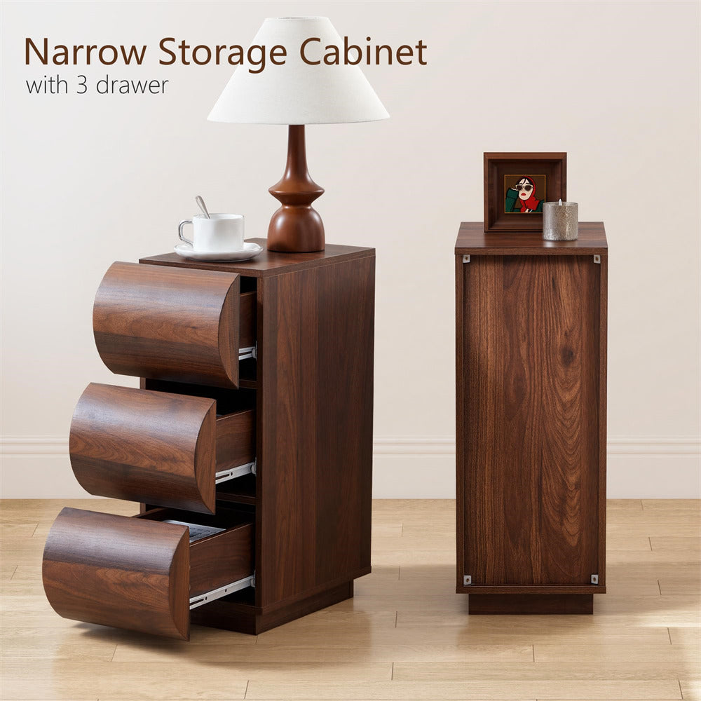 Narrow storage cabinet with three drawers on a wooden floor.