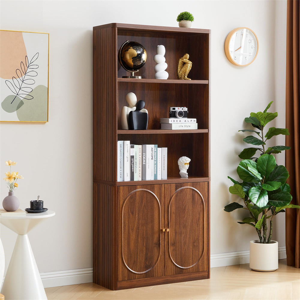Wooden bookshelf with decorative items in a room with a plant and wall art.
