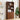 Wooden bookshelf with decorative items in a room with a plant and wall art.