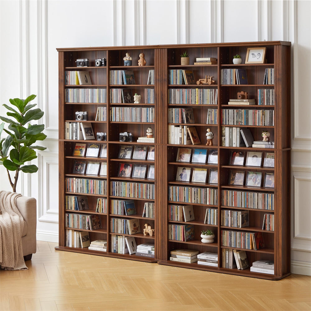 Large wooden bookshelf filled with books and decorative items in a room with a plant and sofa.