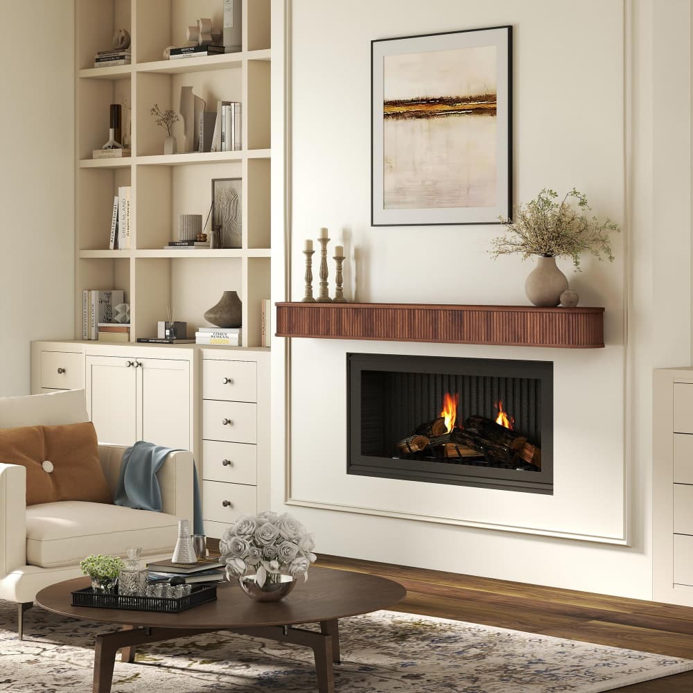 A modern gas fireplace with a wood-look mantel and black firebox insert, styled in a bright living room with a built-in white shelving unit, a cream sofa, and a round wooden coffee table.