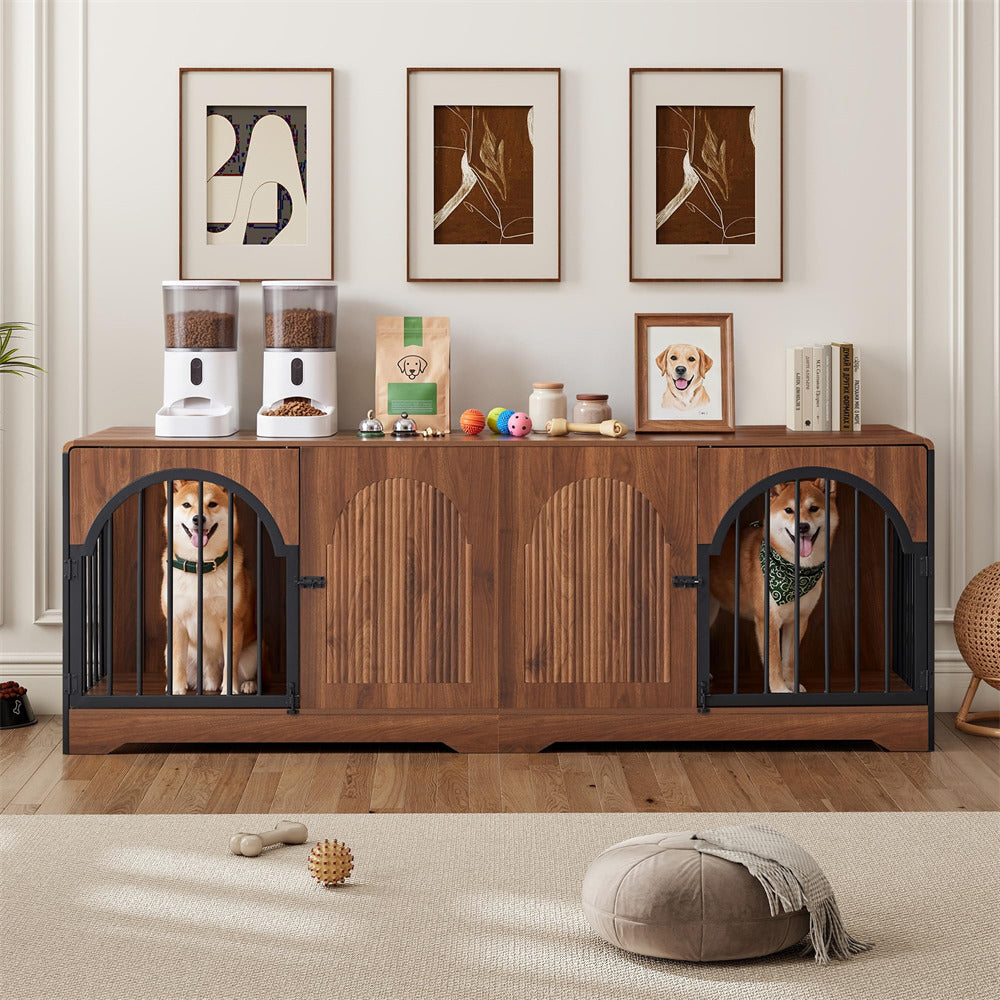 A wooden pet storage cabinet with two black metal dog crates on either side, shown in a styled room with two dogs inside. The cabinet is decorated with pet accessories including automatic waterers, bowls, and a dog portrait frame.