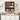 Bathroom with wooden cabinet, sink, and toiletries on a light wood countertop.
