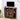 Wooden TV stand with a television and decorative items in a room.