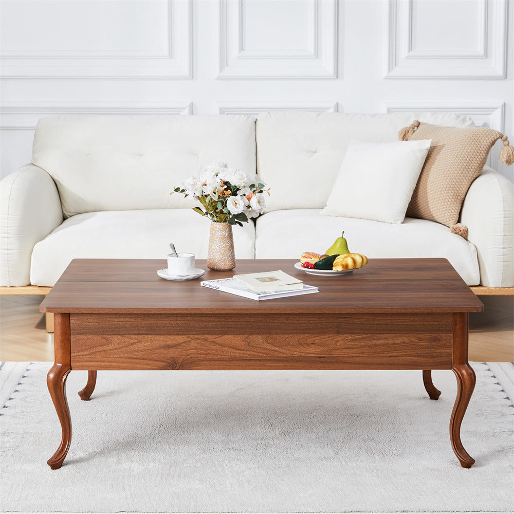 Wooden coffee table with a vase, fruit plate, and newspaper in a living room setting.