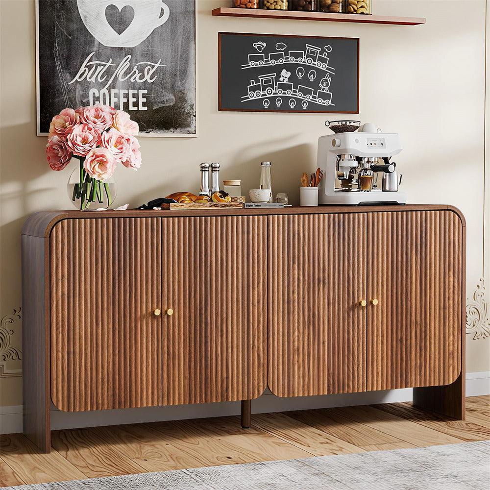 Wooden sideboard with a coffee machine, flowers, and decorative items in a home setting.