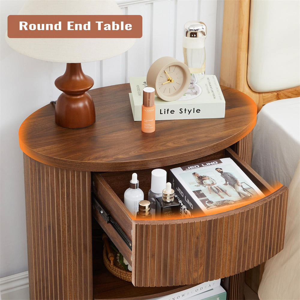 Wooden round end table with various items on a bed