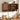 A dark brown wooden kitchen wall cabinet with scalloped doors, shown open to reveal shelves with jars, a mortar and pestle, and a small pot. The cabinet is mounted on a white paneled wall above a wooden countertop with knives, cutting boards, and kitchen utensils.