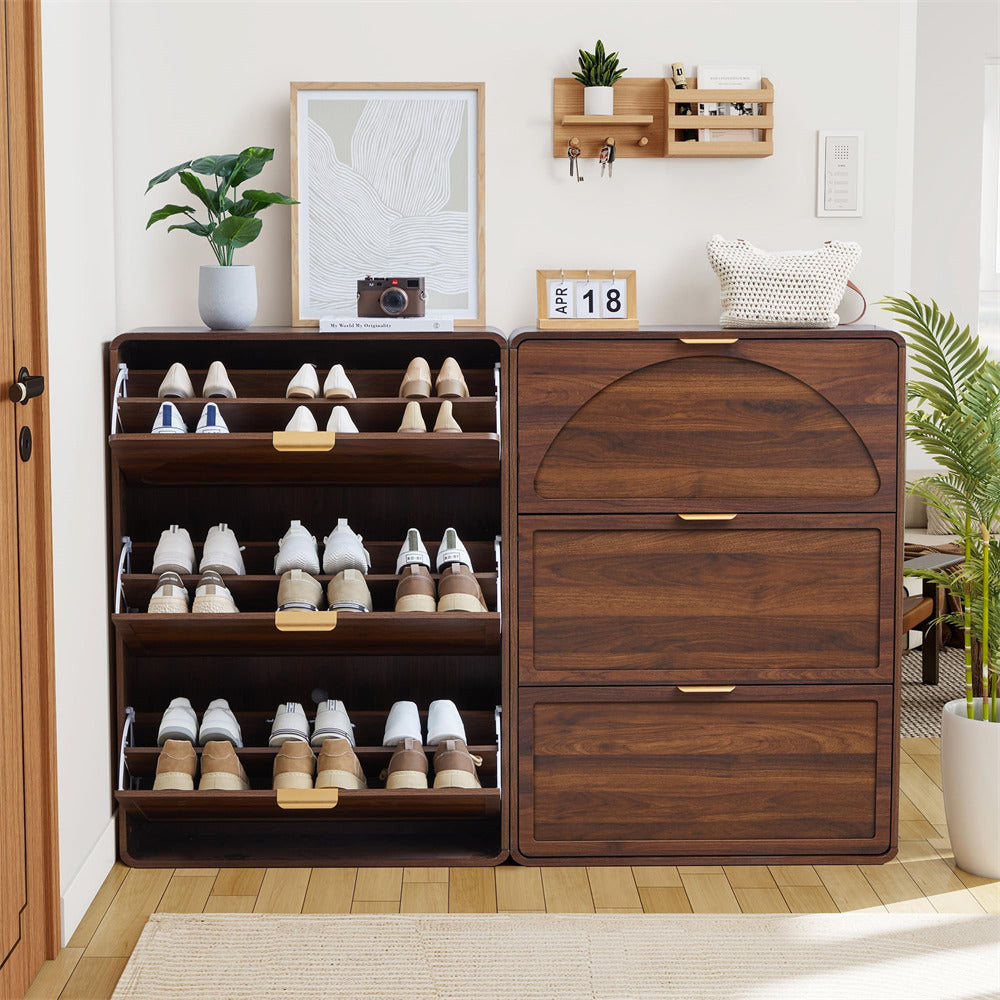 Wooden shoe cabinet with open doors displaying shoes, against a white wall with decor items.