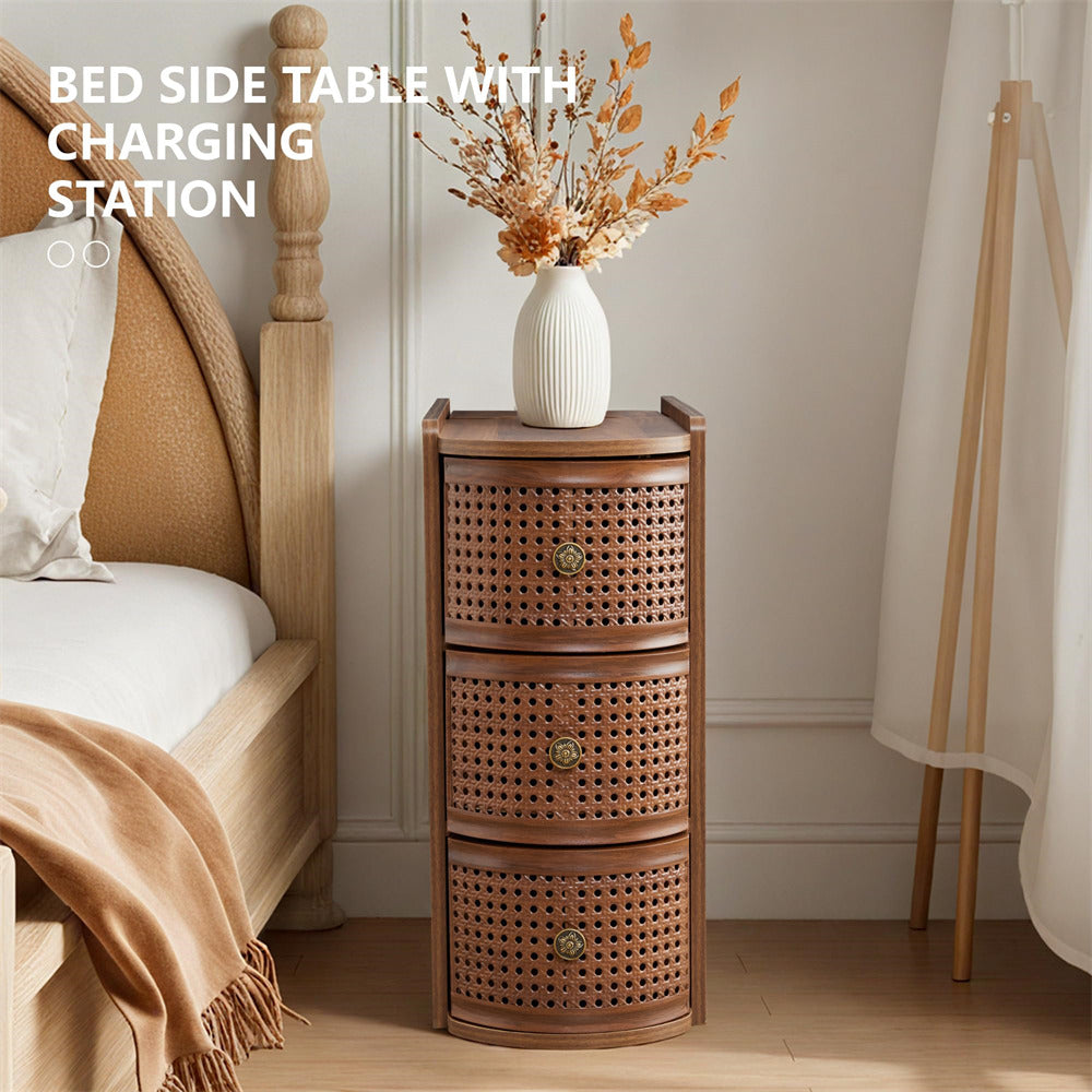Wooden bed side table with charging station next to a bed in a bedroom.