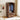 Wooden wardrobe with open doors displaying clothes in a room with a bed and wall art.