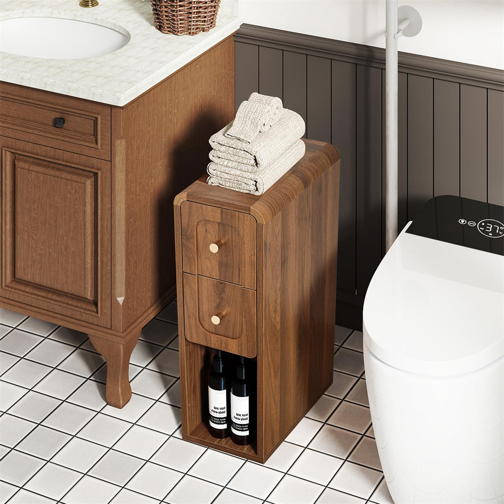 Bathroom with wooden cabinet under sink, towels on top, and bottles inside.