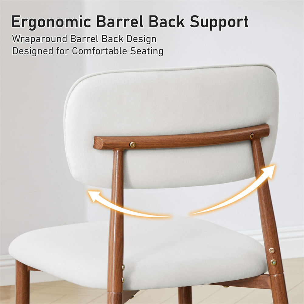 An upholstered dining chair with a light beige seat and back cushion and medium brown wooden frame, shown with text reading 'Ergonomic Barrel Back Support' and yellow arrows indicating curved back support.