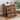 Wooden nightstand with three drawers, decorative items, and a plant in the background.