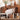 A curved wooden console table shown in a styled room setting with decor items on top, plus three inset detail panels highlighting a drawer, curved design, and side storage shelves.