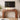 A modern curved wooden console table with a warm walnut finish, styled in a living room setting under a wall-mounted TV, with decorative items on top.