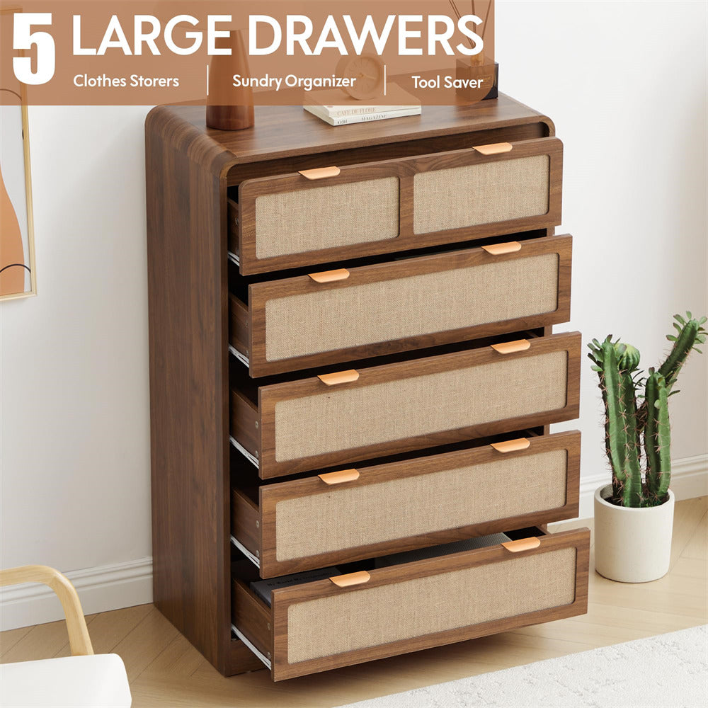 Wooden dresser with five drawers in a room setting with a plant.