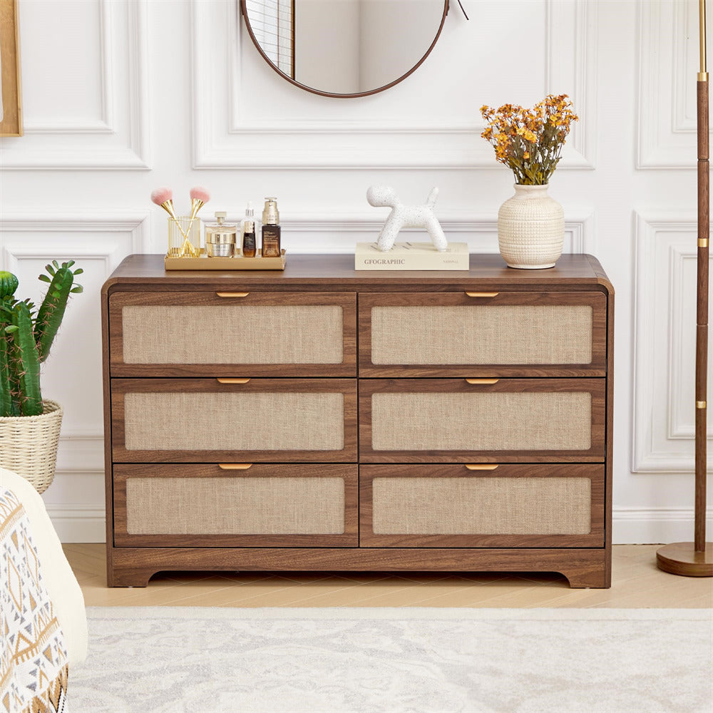 Wooden 6 drawer dressers with decorative items in a bedroom setting