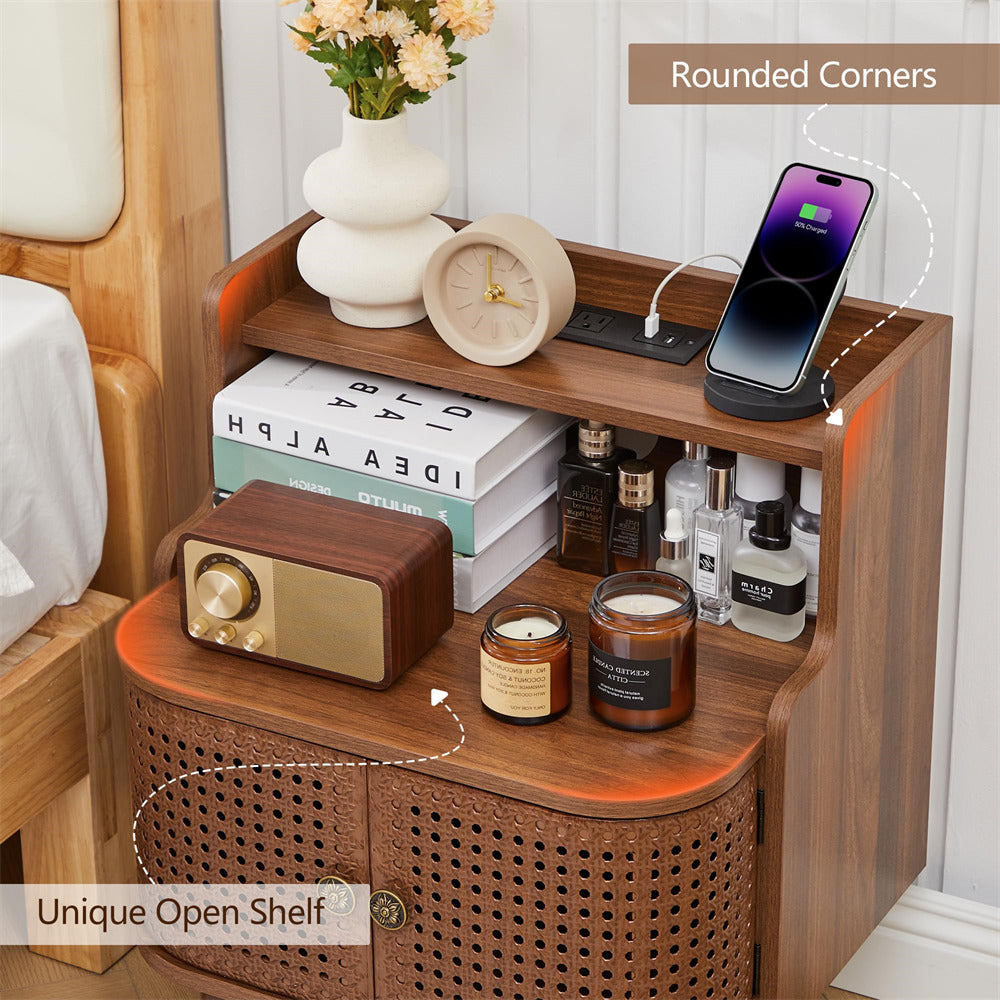 Wooden nightstand with various items including a radio, candles, and a smartphone.