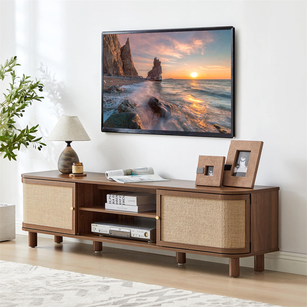 Wooden TV stand with a television displaying a sunset over water, in a living room setting.