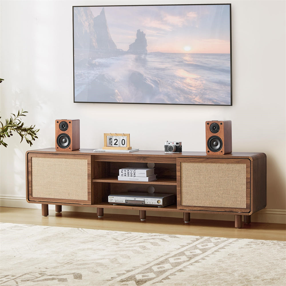 Wooden TV stand with speakers and decor items in a living room setting.