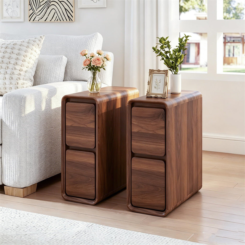 Two matching dark wood side tables with rounded edges and two drawers each, styled in a bright living room next to a white sofa.