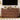 Wooden dresser with decorative items against a wall with a television.