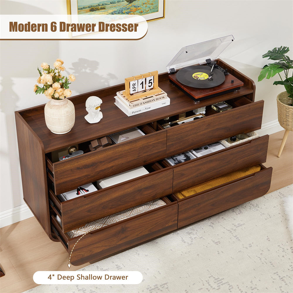 Wooden dresser with multiple drawers, decor items, and a record player in a room setting.