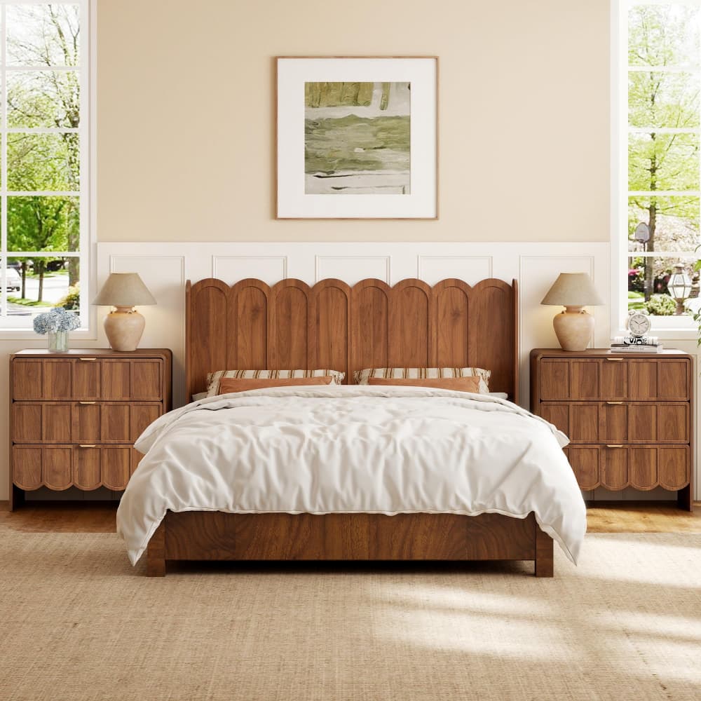 A mid-century modern wooden bed frame with a scalloped headboard, styled in a warm beige bedroom with matching nightstands, bedside tables, and lamps.