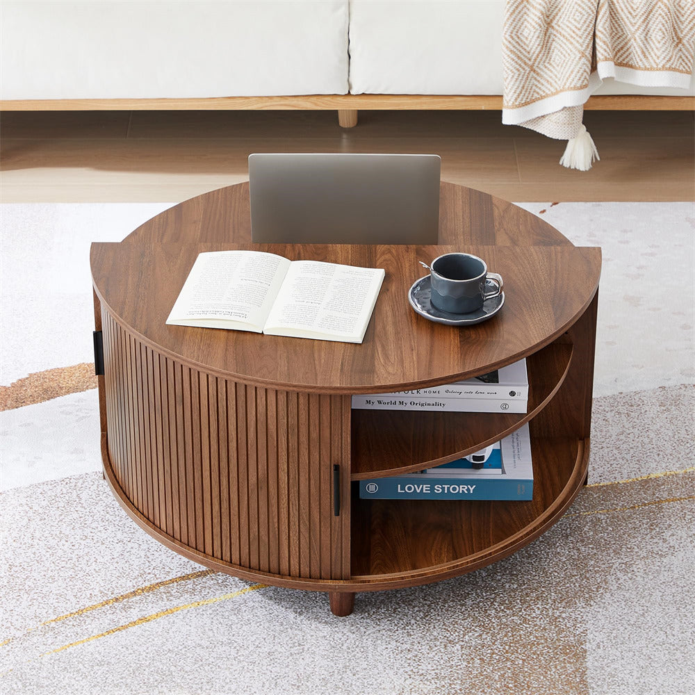 Wooden coffee table with books, a cup, and a laptop in a living room setting.