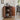 Wooden cabinet with open doors displaying various items in a room with a chair and window.