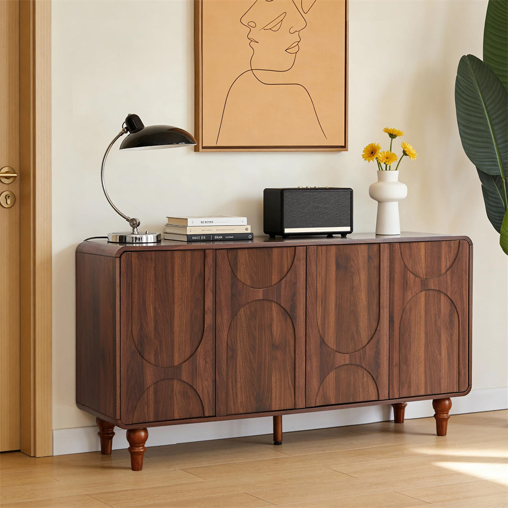 Wooden sideboard with decorative items in a room with a painting and plant.