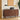 Wooden sideboard with decorative items in a room with a painting and plant.