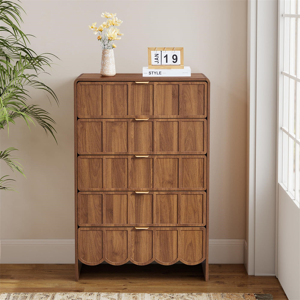 Wooden 5 drawer dresser with decorative items against a neutral wall
