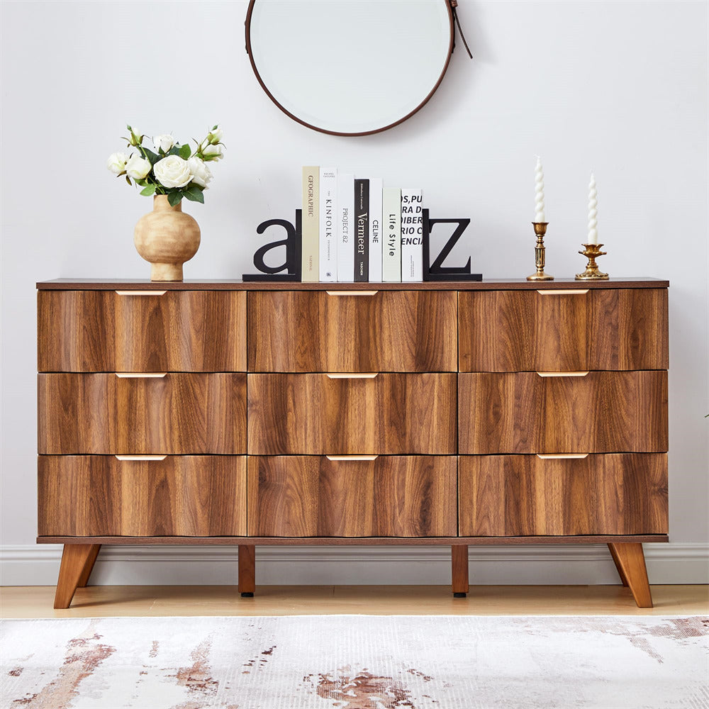 Wooden dresser with decorative items on a light-colored floor and wall.