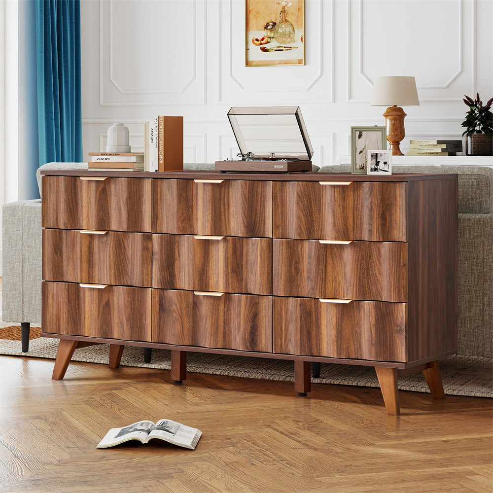 Wooden dresser with a record player on top in a living room setting.