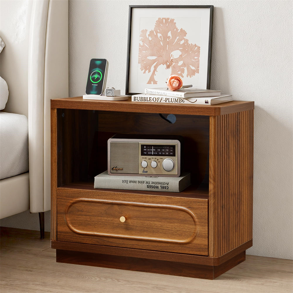 Wooden nightstand with electronic devices and decor items in a bedroom setting