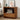 Wooden nightstand with electronic devices and decor items in a bedroom setting