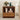 Wooden nightstand with books, a vase of flowers, and electronic devices on a neutral background