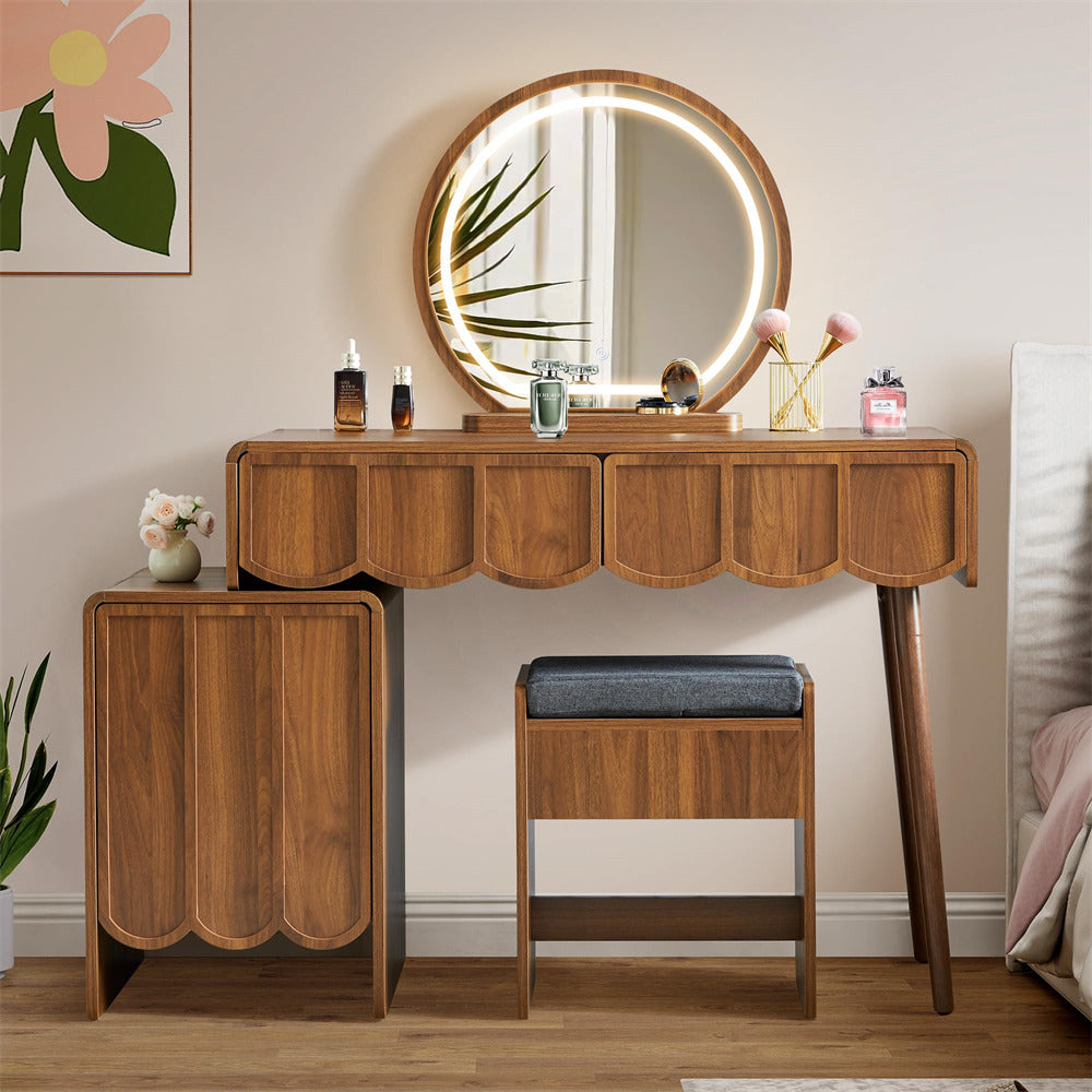 Wooden vanity table with round mirror and stool in a room setting.