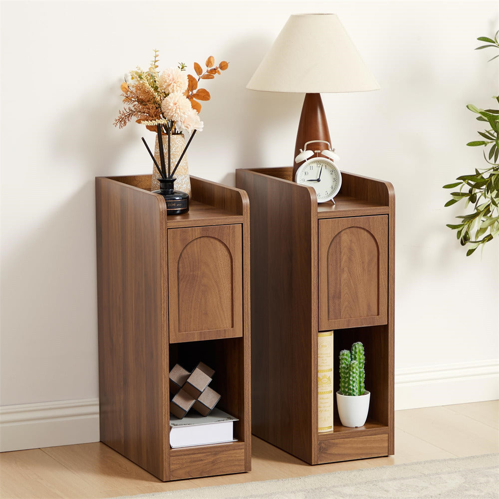 Two wooden side tables with decorative items against a white wall.