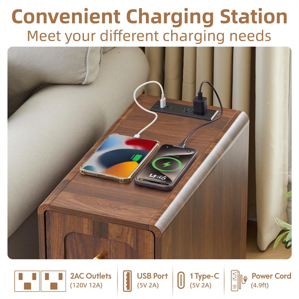 A wooden side table with a built-in charging station, shown in a living room setting next to a sofa. Two smartphones are plugged into the charging ports on top of the table, one with a white cable and one with a black cable.