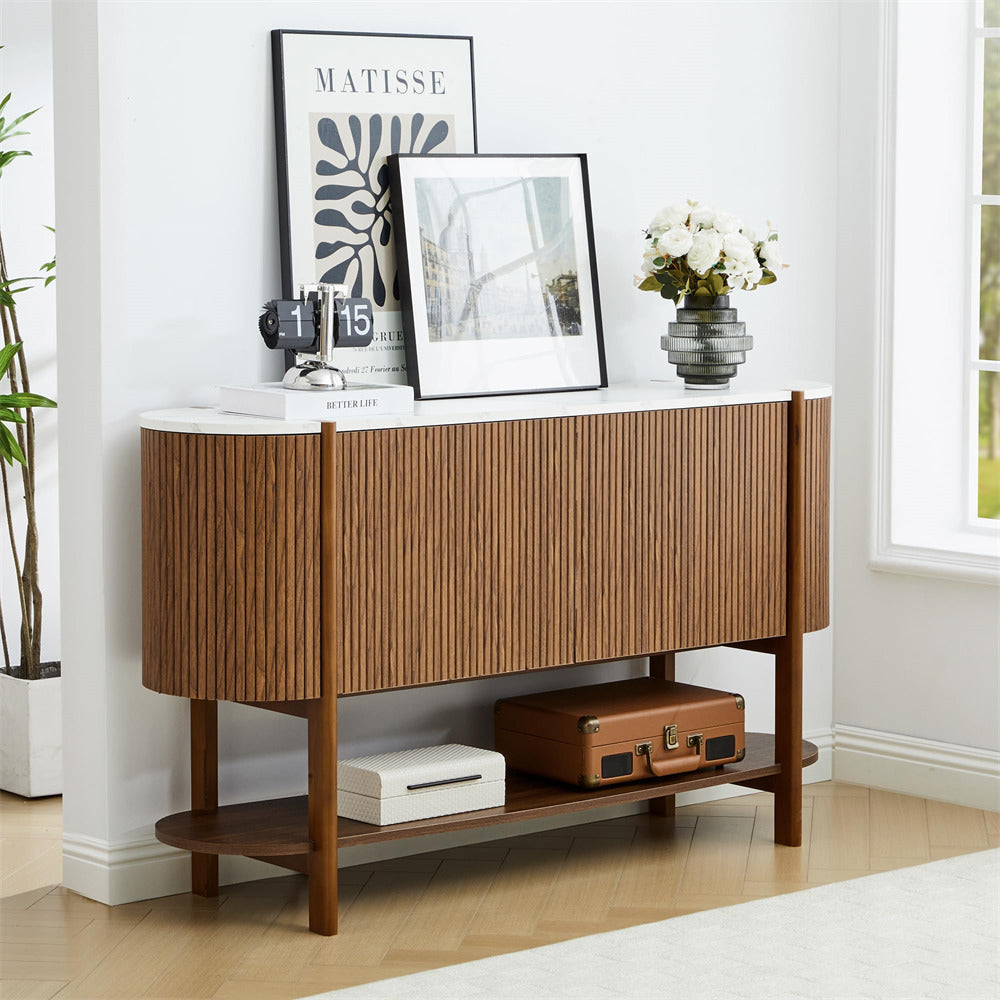 Wooden console table with decorative items in a room with a window and plant.