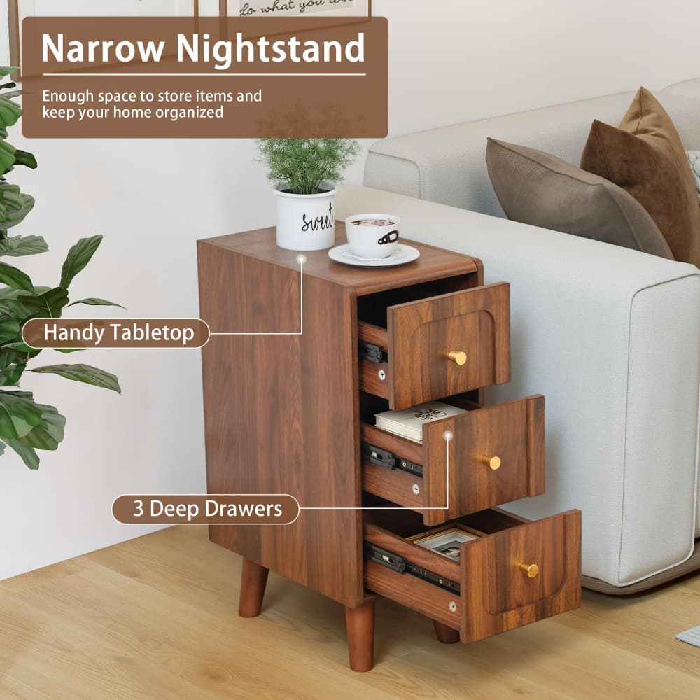 A narrow wooden nightstand with three drawers, shown beside a white sofa in a living room. The nightstand has a warm medium-brown wood finish, small round gold-toned drawer pulls, and tapered legs.