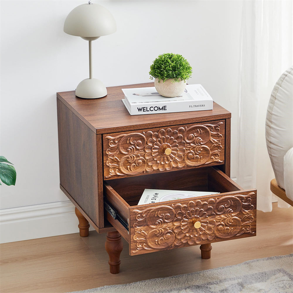 Wooden walnut nightstand with floral carvings, lamp, and books in a room setting.