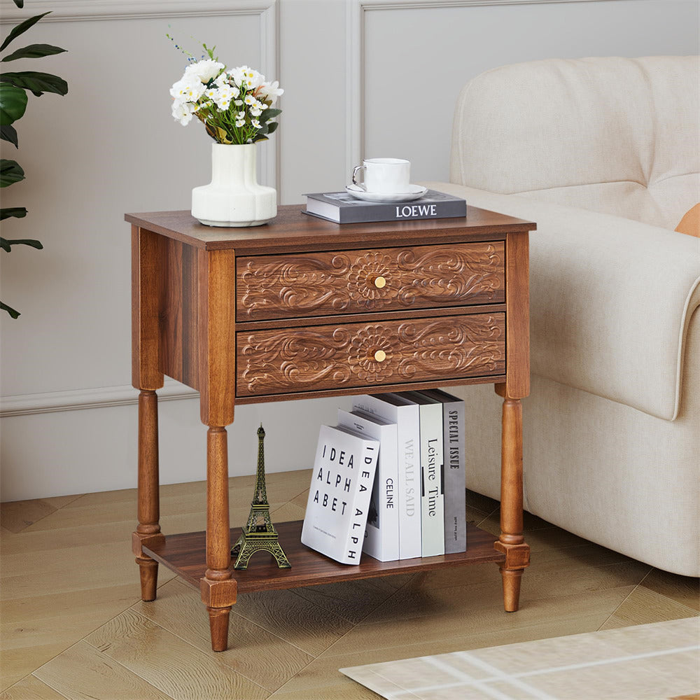 Wooden side table with floral arrangement, books, and a small statue in a living room setting.